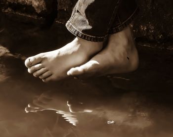 Low section of woman relaxing in water