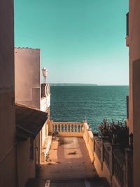 View of swimming pool by sea against clear sky