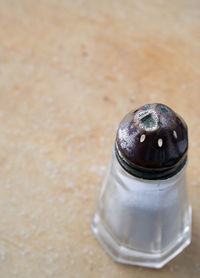 Close-up of salt shaker on table