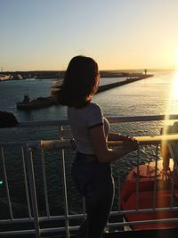Rear view of woman looking at sea against sky