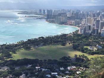 High angle view of buildings and sea against sky