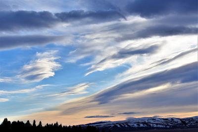 Low angle view of snowcapped mountains against sky during sunset