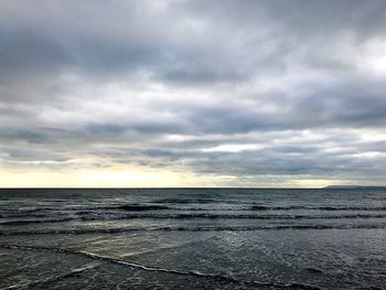 Scenic view of sea against storm clouds