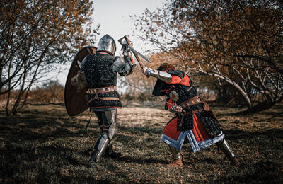 Full length of warriors fighting on field