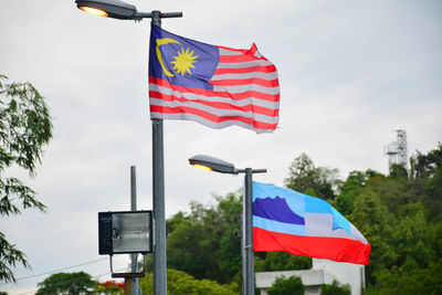 Low angle view of flag against sky