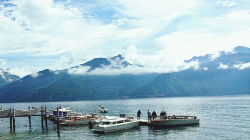 Scenic view of sea and mountains against sky