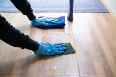 High angle view of hands working on floor at home