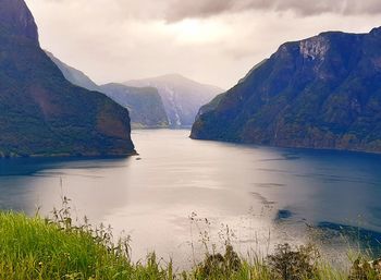 Scenic view of lake and mountains against sky