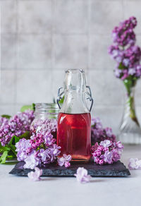 Preparation of syrup from the lilac flowers. glass jar of homemade lilac syrup 