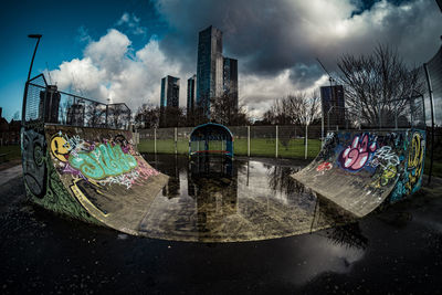 Graffiti on abandoned building against sky in city