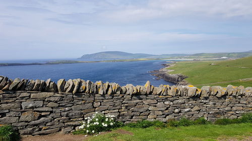 Scenic view of shetland islands against sky at sumbourgh head 