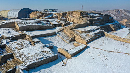 High angle view of traditional windmill against sky during winter