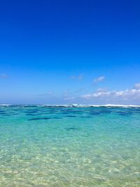 Scenic view of sea against blue sky