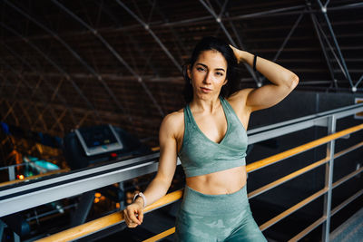 Portrait of young woman standing in gym