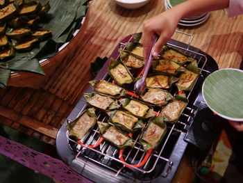 High angle view of person preparing food on barbecue