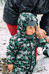 Full length of boy on snow covered land