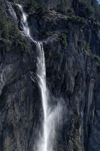 Scenic view of waterfall falling from mountain