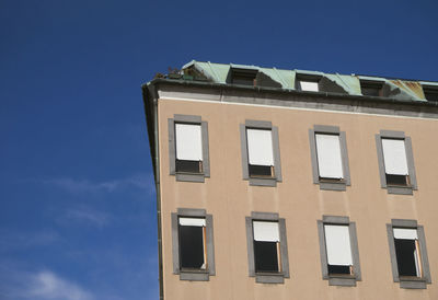 Low angle view of building against blue sky