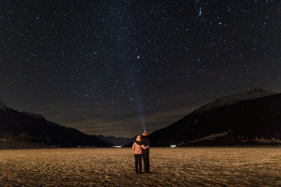 Full length rear view of couple at night