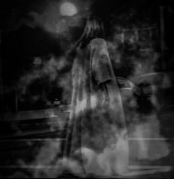 Blurred motion of woman in dark