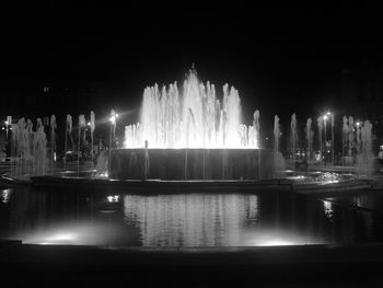 Fountain in city at night