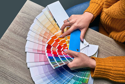 High angle view of woman holding umbrella on table