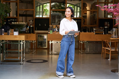 Portrait of young woman standing in gym