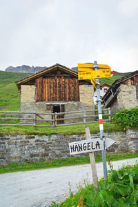 View of road sign against built structure
