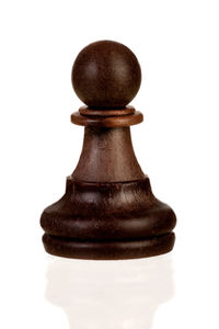 Close-up of chess pieces against white background