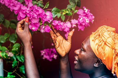 Close-up of woman by flowering plants