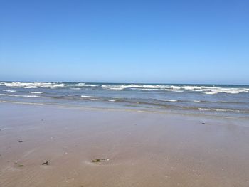 Scenic view of beach against clear sky