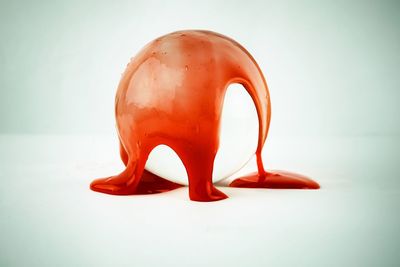 Close-up of red chili pepper against white background