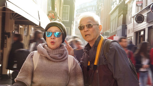 Portrait of friends on street in city