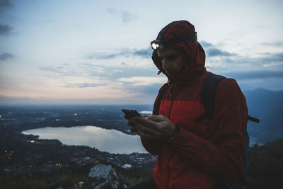 Man using smart phone against sky