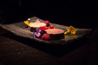 Close-up of dessert on table in darkroom