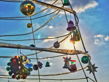 Low angle view of decoration hanging on tree against sky