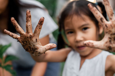 Close-up portrait of boy holding girl