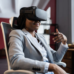 Businesswoman use virtual reality goggles communicate online during vr meeting conference at office