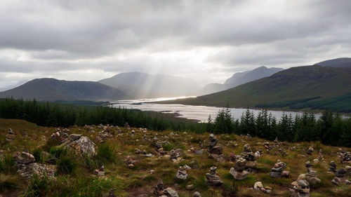 Scenic view of mountains against cloudy sky