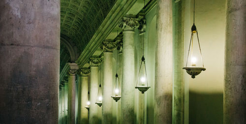 Illuminated lights hanging from ceiling of building