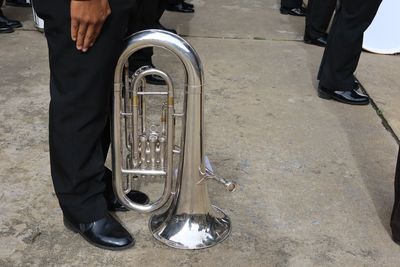 Low section of man playing drum