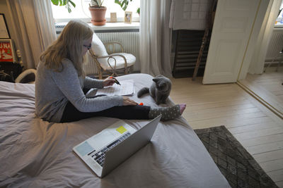 Woman sitting on bed