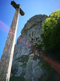 Low angle view of cliff against sky