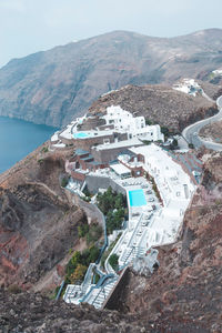 High angle view of buildings by sea against sky