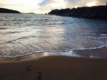 Scenic view of beach against sky during sunset