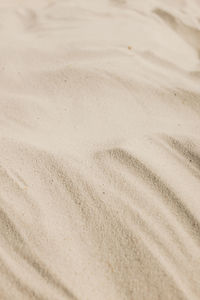 Close-up of tire tracks on sand