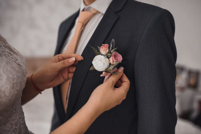 Midsection of bride holding bouquet