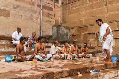 Group of people sitting outside building