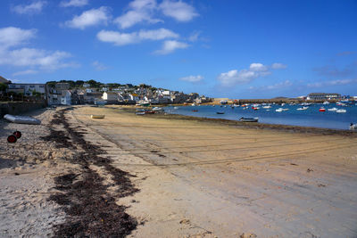 Scenic view of beach against blue sky