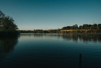 Scenic view of lake against clear blue sky